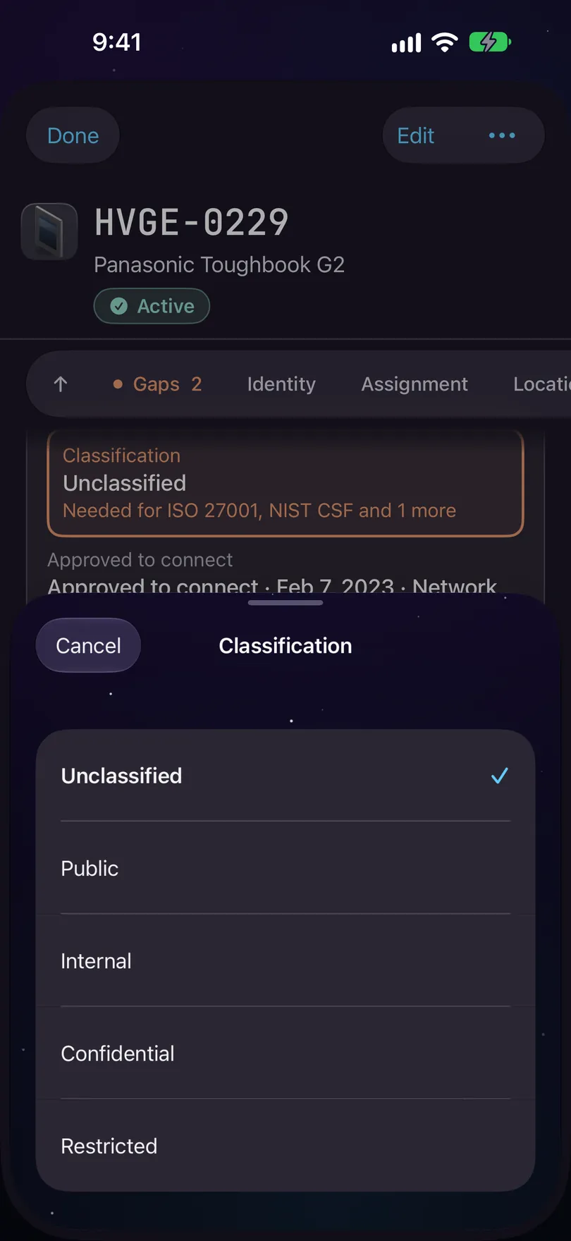 A record on iPhone after tapping Add on a Data classification gap: the field is outlined and reads Needed for ISO 27001, NIST CSF and 1 more, and a Classification editor is open over the lower half of the screen, with Unclassified, Public, Internal, Confidential and Restricted.